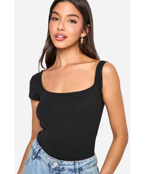 Asymmetric neckline for a unique twist
        One short sleeve and one sleeveless design
        Figure-hugging bodysuit silhouette
        Soft cotton-elastane blend for comfort and stretch
        Versatile piece for layering or wearing alone
    
    Make a statement with this eye-catching asymmetrical bodysuit from Boohoo. The distinctive design features a single short sleeve and an asymmetric neckline, creating a bold and modern look. Perfect for the fashion-forward woman who loves to stand out, this bodysuit can be styled for various occasions. Pair it with high-waisted jeans and trainers for a casual daytime ensemble, or dress it up with a sleek midi skirt and heels for evening drinks. The figure-hugging silhouette flatters your curves, while the cotton-elastane fabric ensures all-day comfort. Layer it under a blazer for a chic office look or wear it solo on warmer days. This versatile piece is a must-have addition to any trendsetter's wardrobe, offering endless styling possibilities for the young woman who wants to stay ahead of the fashion curve.
