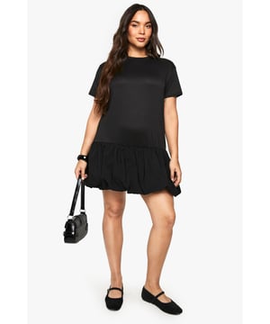 Oversized T-shirt dress with striking contrast print detail
        Relaxed round neckline for everyday comfort
        Short sleeves with clean-cut finish
        Gathered ruffle hem creating playful volume and movement
        Loose, flattering silhouette designed for the plus-size figure
    
    This versatile T-shirt dress combines casual comfort with contemporary flair. The oversized fit creates an effortlessly chic silhouette, whilst the gathered ruffle hem adds a feminine touch to this otherwise minimalist piece. Style with chunky trainers and a crossbody bag, as shown, for daytime outings or family gatherings. For cooler evenings, layer with an oversized denim jacket and accessorise with statement bangles. The contrast print detail adds visual interest to this Boohoo staple that transitions seamlessly from coffee dates to weekend shopping trips. Perfect for those who value both comfort and style, this dress can be customised with belts to define the waist or worn loose for a more relaxed aesthetic.