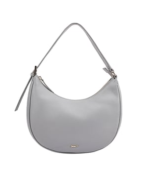 KIEWA a compact half-moon shaped shoulder bag is crafted from smooth leather with a sleek, minimalist design, accentuated by refined piping along the edges and a subtle metal logo pin. The adjustable handle ensures a flexible, comfortable fit, while the interior features both a zip pocket and a slip pocket to keep your essentials organized in style. D:10cm W:27cm H:22.5cm