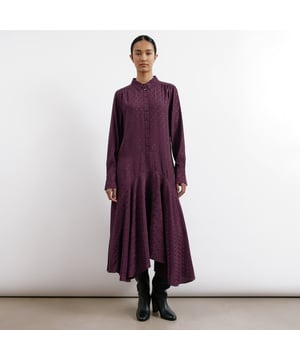 Indulge in the decadent burgundy hue of this midi dress, crafted from sumptuous satin jacquard and adorned with a delicate spot pattern. The classic shirt collar and button front placket add a touch of sophistication, while side pockets provide convenience. This dress features a dropped waist and a flattering dipped hemline, exuding elegance and grace.