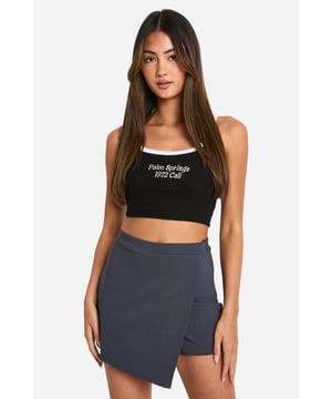 Asymmetrical wrap-style design for a unique silhouette
        Smooth bengaline fabric offers comfort and flexibility
        High-waisted fit accentuates the waistline
        Versatile skort combines the look of a skirt with the practicality of shorts
        Sleek, minimalist style suitable for various casual occasions
    
    Make a statement with these eye-catching asymmetrical skorts from Boohoo. Perfect for the fashion-forward woman who values both style and comfort, these skorts offer a fresh take on casual wear. The wrap-style design creates an intriguing silhouette that's sure to turn heads, while the bengaline fabric ensures a smooth, flattering fit that moves with you. Pair with a cropped top, as shown, for a trendy ensemble that's ideal for brunch with friends or a day out shopping. For a more laid-back look, team with a loose-fitting tee and trainers. These versatile skorts can easily transition from day to night - simply swap your flats for heels and add some statement jewellery for an evening look that's both chic and comfortable. Whether you're heading to a family gathering or a casual date, these skorts offer the perfect blend of style and practicality.