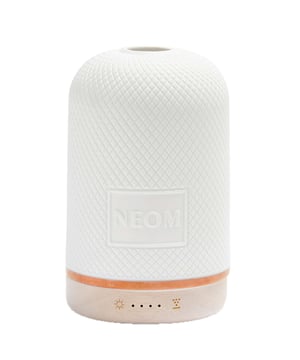 Experience the transformative power of the Neom Wellbeing Pod, designed to enhance your environment and promote wellbeing. This home fragrance device uses 100% natural essential oil blends to relieve stress, boost energy, and improve sleep quality. With its sleek white ceramic cover and upcycled wood base, the Wellbeing Pod fits beautifully in any space. Touch a button to fill your home with uplifting scents that create a calming atmosphere. Neom is a Certified B Corporation committed to ethical practices. Note, essential oil blends are sold separately.