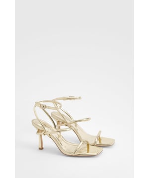 Striking metallic finish for a glamorous look
        Delicate strappy design with ankle fastening
        Square toe for a modern, on-trend silhouette
        High heel between 7 and 9cm for added height and elegance
        Versatile style suitable for various evening occasions
    
    Step into the spotlight with these eye-catching metallic strappy sandals from Boohoo. Perfect for the fashion-forward woman who loves to make a statement, these heels are designed to turn heads at any nighttime event. The intricate strappy design wraps elegantly around the foot and ankle, providing both style and support. The square toe adds a contemporary edge, while the high heel offers a confidence-boosting lift. Ideal for a night out on the town, these sandals pair beautifully with a sleek mini dress or tailored trousers and a crop top. Whether you're dancing the night away at a club or enjoying cocktails at a trendy bar, these versatile heels will keep you looking chic from dusk till dawn. Embrace your inner party girl and let these metallic marvels be the finishing touch to your show-stopping ensemble.