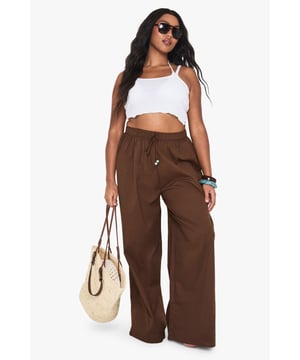 Low rise design with wide-leg silhouette for effortless beach style
        Decorative beaded detail adds a touch of bohemian charm
        Lightweight linen fabric ensures breathability in warm weather
        Relaxed fit with flowing wide legs for unrestricted movement
        Drawstring detail with beaded ends for adjustable comfort
    
    These Plus Linen Beaded Low Rise Beach Trousers from boohoo are your essential holiday companion. The breezy linen construction keeps you cool whilst lounging poolside or strolling along sandy shores. Style them with a simple crop top as shown for a carefree daytime look, or pair with a flowing kimono and sandals for sunset beach dinners. The wide-leg design creates a flattering silhouette that moves beautifully in the sea breeze, whilst the beaded detailing adds a distinctive touch to your resort wardrobe. Perfect for packing in your suitcase for hot destinations, these trousers transition seamlessly from beach to bar. Complete the look with oversized sunglasses and a woven beach bag for the ultimate holiday ensemble that combines comfort with on-trend style.