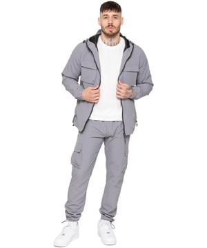 Gear up with the Enzo Milano Men’s Lightweight Cargo Jacket & Pants Set, built for comfort, function, and style. The jacket features water-repellent crushed poly fabric with a breathable mesh lining, full zip front, adjustable hood, and multiple secure pockets. Paired with lightweight cargo pants in a regular fit, this set includes an elasticated waistband with drawstring, cargo pockets, and adjustable hems for a personalized fit.