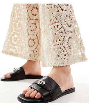 Shoes by Public Desire Wide Fit Step into summer Wide strap Slip-on style Hardware detail Open toe Flat soleSold By: Asos