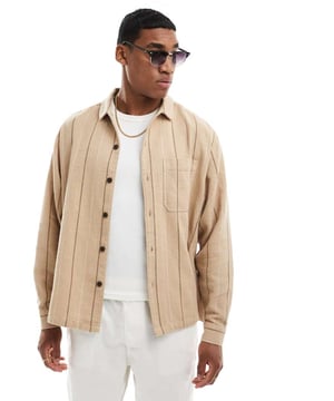 Shirts by ASOS DESIGN We like your style Stripe design Spread collar Button placket Chest pocket Boxy, oversized fitSold By: Asos