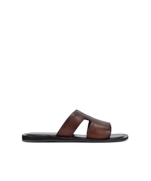This KG Kurt Geiger Venice is a slip-on sandals crafted from a brown textured leather. The footbed is lightly padded.