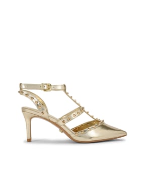 This Carvela Samba Court heel features a gold upper with statement gold studs across the straps. The enclosed toe is pointed, and the heel is in a stiletto style. Heel height: 70mm.
