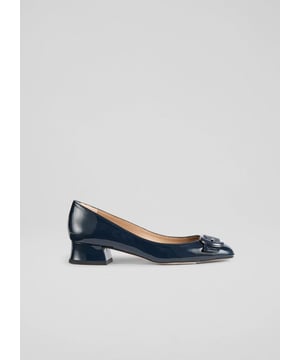The Cici court pumps, in a striking blue patent leather, feature a stylish resin buckle and a comfortable block heel, perfect for smart-casual occasions. Pair them with tailored trousers or a sleek skirt to enhance your ensemble. Made in Spain. Ideal for brunch dates or office meetings where you want to impress without trying too hard.