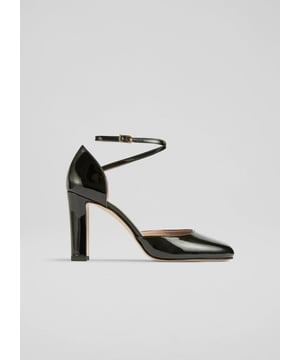 Experience elegance with the Adaline ankle cross heel, an Italian masterpiece. Crafted from patent black leather, it features a round toe and block heel. Versatile and ideal for brunch or the office. Pair with tailored trousers for a polished look or a midi dress for sophistication.