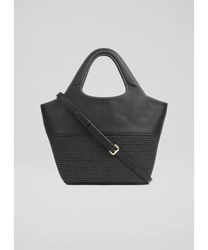 The Carly crossbody tote is a sophisticated addition to any wardrobe. In timeless black, this textured bag features a fabric blend, complemented by new branding accents. Perfect for casual brunches or day outings, pair it effortlessly with trousers or a flowing skirt for an elevated look.