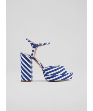 The Rosa twist front platform in a captivating blue print is crafted from 100% cotton fabric with a leather lining, featuring an almond toe and a block heel. Perfect for a night out or a special occasion, pair these shoes with your favourite cocktail dress or tailored trousers for an unforgettable ensemble.