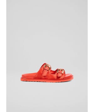 Unveiling the Capri sandals, a highlight in red satin with double strap design and gold buckle detail. This style offers a moulded footbed for support, making every step a comfort-driven experience. Ideal for a garden party or a casual beach outing, pair them with a flowy summer dress or crisp white trousers for a stylish look.