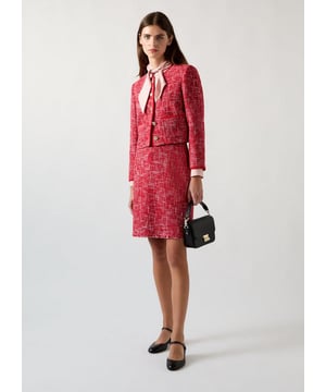 Embrace chic allure with the Alexa tweed jacket, a blend of sophistication. This red cotton blend design features plaited rope trims and gold buttons, exuding elegance. Pair with tailored trousers or a pencil skirt for a smart-casual look. Ideal for office meetings, dinner parties, or classy outings, this jacket guarantees to make a statement.
