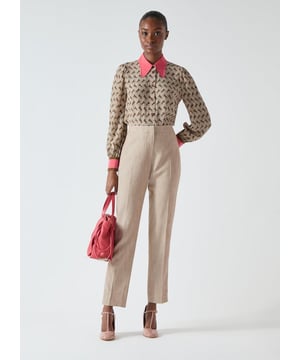 Introducing the Amelia trousers, crafted from Portuguese fabric, an essential for your workwear wardrobe. In a beige hue, this slim-leg trouser features a side leg cord effect trim and non-functional back pocket for a streamlined look. Perfect for the office, style with a white blouse and classic court shoes for an office-ready ensemble.