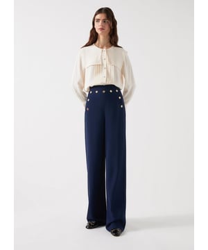Embrace nautical elegance with our navy blue olive crepe sailor trouser. Crafted from viscose, it features gold metal buttons and a concealed side zip. Perfect for brunch or an evening out, pair with a white blouse or fitted blazer for a sophisticated smart-casual look.