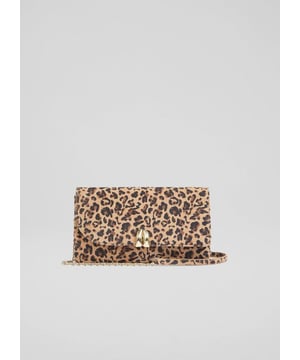 The Aria curve flap clutch bag is crafted from luxurious printed suede in a deep brown shade and lined with soft cotton. This Spanish-made accessory showcases exquisite craftsmanship. Perfect for pairing with your favorite tailored outfit or a flowing dress, it promises a refined look thatâ€™s sure to turn heads.