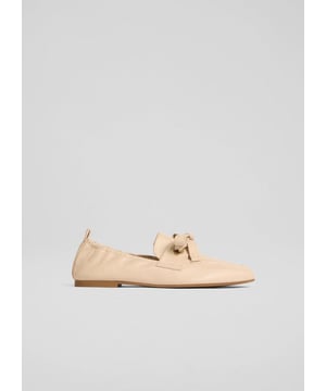 The Maude eyelet bow loafers are perfect for life's casual moments like brunch with friends or a relaxed day at the office. Made in Spain, these black nappa leather flats feature a round toe and bow detail for a touch of sophistication. Pair them with tailored trousers or a midi skirt for a refined everyday look.