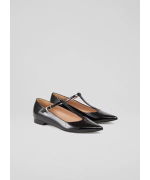 Our Drew T-bar flats blend sophistication with comfort. These black patent flats are crafted in Spain from 100% leather, featuring a pointed toe design that embodies smart casual style. Perfect for pairing with tailored trousers for a polished office look or a chic midi dress for a weekend brunch, these flats are a must-have for the fashion-forward wardrobe.
