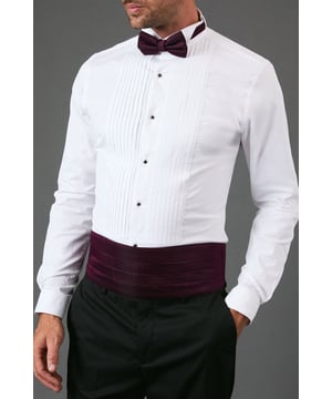 Matching cummerbund and bow tie set in rich burgundy for coordinated formal styling
        Pre-tied bow tie with adjustable neck strap for hassle-free wear
        Pleated cummerbund designed to sit comfortably at the waist
        Classic formal accessory set that adds sophistication to any dress shirt
        One size design with adjustable features to ensure proper fit
    
    Complete your formal ensemble with this Burton cummerbund and bow tie set, the perfect finishing touch for black-tie events and special occasions. The rich burgundy hue adds a distinguished touch to the traditional formal look, pairing beautifully with a crisp white dress shirt and black trousers as shown. The pre-tied bow tie features an adjustable strap for comfort, while the pleated cummerbund sits elegantly at the waist, creating a polished silhouette. This versatile set works brilliantly for weddings, formal dinners, and awards ceremonies, but can also be styled for semi-formal gatherings when you want to make an impression. For a contemporary twist, consider wearing just the bow tie with a white shirt and waistcoat for smart-casual events. Machine washable at 30 degrees, this practical yet refined accessory set ensures you'll always be ready for your next special occasion.