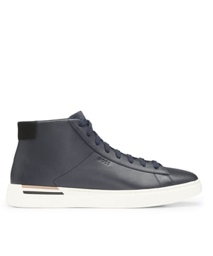 Heren BOSS Clint Leren High-Top Trainers met signature streep in donkerblauwDeze glad leren high-top trainers van BOSS Menswear kunnen zowel omhoog als omlaag gekleed worden. Sierstreep voor een opvallende stijl. Rubberen zool. Afwerking op de rubberen zool. Vetersluiting. Subtiel logo. We zoeken voortdurend naar meer verantwoorde manieren om onze producten te produceren en af te werken. Minimaal 60% van het leer dat is gebruikt om dit product te maken, is afkomstig van gecertificeerde leerlooierijen.- Veters- Volledig gevoerd- Verpakking: Doos- Bovenmateriaal: 100% Koeienhuid.  Voering: 100% Polyester 60% Polyester 40% Polyurethaan.  Zool: 100% Rubber.  Binnenzool: 100% Polyester.- Ref: 50543437-401