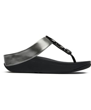 The Fitflop Halo Bead Circle Metallic sandals blend style with comfort in a sophisticated package. These women's flip flops showcase a distinctive metallic finish with elegant circular bead detailing that catches the light beautifully. The synthetic upper sits atop Fitflop's renowned comfort-engineered rubber sole, providing exceptional support for all-day wear. Perfect for warm-weather outings or casual evenings, these flats offer that rare combination of head-turning style and blissful comfort that keeps Fitflop enthusiasts coming back for more.