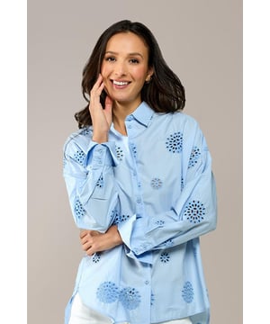 TREND-ALERT! Maak je zomeroutfits compleet met de perfecte blouse. De lichtblauwe kleur in combinatie met de verfijnde broderie brengt meteen een vakantiegevoel. Deze blauwe damesblouse heeft een rechte pasvorm die tot op de heup valt. De lange mouwen zijn afgewerkt met brede manchetten die je kunt omslaan voor een moderne look. Combineer de blouse met een lichtblauwe jeans voor een ton-sur-ton effect en voeg een gekleurde sandaal toe voor een speelse, kleurrijke touch. De oversized pasvorm maakt het ontwerp extra trendy met een verrassende twist! Gemaakt van 100% katoen, is deze blouse heerlijk luchtig en ideaal voor warmere dagen. Mix en match eindeloos met andere stukken uit de nieuwe collectie van Caroline Tensen.