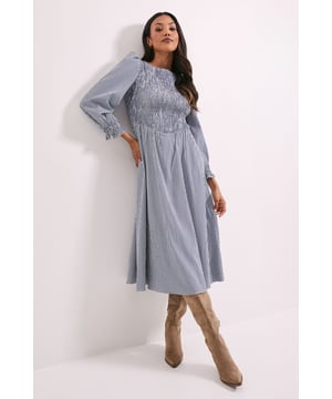 Charming gingham pattern with elegant shirred bodice detail for a flattering fit
        Blouson sleeves add a romantic touch with gentle volume and feminine silhouette
        Midi length offers versatile coverage, perfect for day-to-evening transitions
        Crew neckline provides a modest and universally flattering finish
        Comfortable stretch woven fabric allows for ease of movement throughout the day
    
    This Dorothy Perkins gingham midi dress combines timeless charm with modern comfort. The shirred bodice creates a beautifully fitted waistline that flows into a graceful A-line skirt, while the blouson sleeves add just the right amount of romantic flair. Style with knee-high boots for a chic autumn ensemble, or pair with ballet flats and a denim jacket for weekend brunches with friends. The versatile midi length makes this dress perfect for family gatherings, baby showers, or casual office days. For cooler weather, layer with a lightweight cardigan and accessorise with a crossbody bag as shown. The classic gingham pattern offers enduring appeal that transcends seasonal trends, making this a wardrobe staple you'll reach for time and again. Machine washable for effortless care.