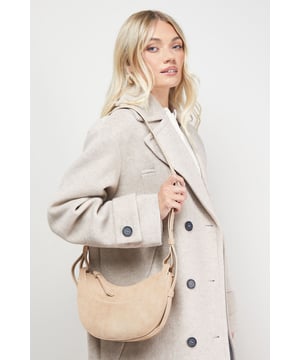 Distinctive half-moon silhouette for a contemporary aesthetic
        Soft faux suede texture adds a luxurious touch to casual outfits
        Adjustable crossbody strap for comfortable all-day wear
        Secure zip-top closure to keep essentials safe
        Compact yet spacious enough for daily necessities
    
    The Relly Faux Suede Half Moon Crossbody Bag combines practicality with feminine charm, embodying Oasis's signature style. The curved silhouette creates a soft, modern look that pairs beautifully with both casual and smart-casual ensembles. Style with relaxed denim and a floaty blouse for daytime outings, or match with a floral day dress for garden parties and family gatherings. The versatile design makes it perfect for weekend shopping trips, coffee dates, or casual lunches. The adjustable strap allows for customised wear, while the interior provides just enough room for your phone, wallet, keys and lipstick. This bag effortlessly transitions from day to evening, making it an essential addition to your accessory collection for those moments when you want to travel light without compromising on style.