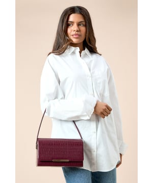 Structured shoulder bag with eye-catching croc print texture
        Sleek metal bar detail adorning the front flap
        Versatile top handle for easy carrying
        Compact size perfect for essentials
        Secure flap closure to keep belongings safe
    
    Make a statement with this chic croc print structured shoulder bag from Dorothy Perkins. Its compact yet practical design is ideal for the fashion-forward woman who values both style and functionality. The textured exterior adds a touch of sophistication, while the sleek metal bar detail on the front flap gives it a modern edge. Perfect for a night out with friends or a trendy brunch date, this bag effortlessly transitions from day to evening wear. Pair it with a sleek midi dress and strappy heels for a polished look, or dress it down with tailored trousers and a blouse for a more casual yet refined ensemble. The versatile design allows you to carry it by the top handle or wear it over the shoulder, adapting to your needs throughout the day. This bag is a must-have accessory for the woman who wants to add a dash of urban chic to her wardrobe without compromising on practicality.