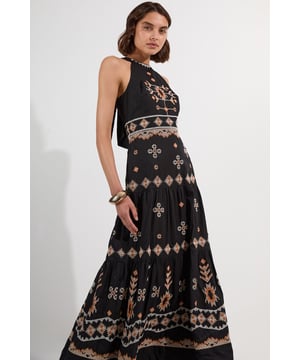 This Karen Millen halter maxi dress combines artisanal embroidery with contemporary design for effortless daytime sophistication. The intricate geometric patterns and delicate detailing create visual interest against the woven fabric, whilst the flowing tiered skirt offers graceful movement with every step. The versatile halterneck design showcases your shoulders, making it perfect for summer garden parties or holiday escapes. Layer with a lightweight denim jacket when the temperature drops, or simply let the exquisite embroidery take centre stage for a look that's both relaxed and refined.  Striking halterneck design with intricate embroidered pattern throughout Maxi length with tiered skirt Crafted from cotton-lined woven fabric Distinctive geometric and floral embroidery Figure-flattering silhouette with defined waistband