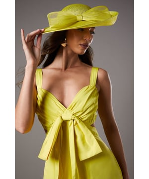 Striking wide brim design crafted from natural Abaca fabric for a lightweight yet structured silhouette
        Elegant bow detail adds a feminine touch and creates a focal point for your occasion ensemble
        Versatile one-size design suitable for various head shapes and hairstyles
        Dramatic brim provides stylish sun protection whilst framing the face beautifully
        Handcrafted construction ensures each hat maintains its distinctive character and shape
    
    The Lisa Tan Wide Brim Hat exemplifies Coast's signature sophistication, perfect for elevating your special occasion attire. The dramatic silhouette creates an instant statement, whilst the delicate bow detail adds a touch of refined femininity. Style with a coordinating dress as shown by our model for a harmonious look, or create contrast with complementary tones for added visual interest. This hat works beautifully for summer weddings, race day events, or garden parties where you wish to make an impression. The natural Abaca construction offers both structure and breathability, ensuring comfort throughout your event. For travel, store flat or upside down in a hat box to maintain its distinctive shape. A truly timeless accessory that will serve you for numerous special occasions.