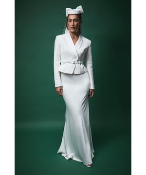 Luxurious satin bias cut maxi skirt with elegant floor-sweeping length
        Sleek, figure-flattering silhouette that gracefully skims the body
        Smooth, flowing fabric that creates beautiful movement when walking
        Sophisticated high-waisted design for a lengthening effect
        Subtle flare towards the hem creating a stunning mermaid-like shape
    
    The Lisa Tan Satin Bias Cut Maxi Skirt from Coast exemplifies timeless bridal elegance. The bias cut construction allows the satin fabric to drape beautifully, creating a fluid silhouette that moves gracefully with every step. Perfect for the modern bride seeking sophistication, this skirt pairs wonderfully with the structured jacket shown, creating a contemporary two-piece bridal ensemble. The high waist and flowing lines elongate the figure, whilst the subtle flare adds dramatic flair. Style with delicate jewellery and an elegant updo for your ceremony, then transition effortlessly to your reception. This versatile piece could also be styled differently post-wedding for special occasions, making it a treasured addition to your wardrobe beyond your special day.