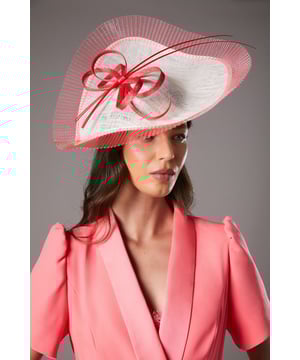 Statement side-facing design with dramatic wide brim for sophisticated impact
        Adorned with elegant quill detailing and decorative loop embellishment
        Lightweight Abaca construction offers comfort throughout day-long events
        Sculptural silhouette creates a striking profile perfect for formal occasions
        Secured fit allows for confident wear even in breezy outdoor settings
    
    Make a captivating entrance at your next special occasion with the Lisa Tan fascinator from Coast. This side-facing design commands attention with its artistic quill and loop detailing that adds movement and dimension. The wide, sweeping brim frames the face beautifully while providing a touch of shade. Style with a tailored blazer in a complementary hue as shown for a coordinated ensemble that works brilliantly for summer weddings, garden parties or race day events. The fascinator's architectural form balances perfectly with sleek, minimalist outfits - pair with a structured dress and refined court shoes for a look that photographs magnificently. This versatile headpiece transitions effortlessly from daytime celebrations to evening receptions, ensuring you remain the epitome of British elegance throughout your special event.