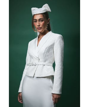 Exquisite boucle fabric adorned with delicate sequin embellishment for a subtle shimmer
        Sophisticated V-neckline with elegant lapel detailing
        Fitted silhouette with structured shoulders for a refined shape
        Matching belt to accentuate the waist and create a flattering profile
        Versatile cropped length perfect for bridal occasions and formal events
    
    Make a striking impression on your special day with this Lisa Tan Boucle Sequin Fitted Jacket. The textured fabric catches the light beautifully whilst maintaining a sophisticated aesthetic that's perfect for bridal celebrations. Style with the matching skirt as shown for a contemporary bridal ensemble that combines tradition with modern elegance. The belted waist creates a feminine silhouette, whilst the structured shoulders and V-neckline frame your dcolletage beautifully. Complete your bridal look with statement earrings and an elegant bow headpiece for a touch of refined glamour. This Coast jacket transitions effortlessly from ceremony to reception, ensuring you look impeccable throughout your wedding day celebrations. Pair with minimal accessories to let this stunning jacket take centre stage.