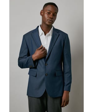 Textured woven fabric adds subtle depth and visual interest to this regular fit blazer
        Classic notched lapels and two-button front closure for a timeless silhouette
        Functional front pockets provide both practicality and traditional tailoring detail
        Regular fit design offers comfortable movement while maintaining a smart appearance
        Clean-lined back with central vent ensures ease of movement and a flattering drape
    
    This Maine textured blazer combines classic British tailoring with contemporary versatility. The regular fit provides a traditional silhouette with comfortable room across the shoulders and chest, making it ideal for all-day wear. Style as seen with a crisp white shirt and dark trousers for sophisticated smart-casual occasions, or dress it up with coordinating formal trousers and Oxford shoes for business meetings. The versatile design transitions seamlessly from office to evening events, whilst the textured fabric adds subtle character to your ensemble. Perfect for those seeking a refined addition to their wardrobe that works across multiple settings - from important presentations to dinner dates and weekend gatherings where you want to convey polished confidence without appearing overdressed.