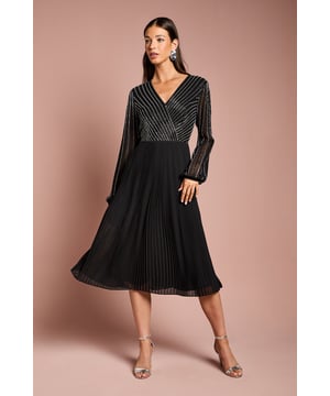 Exquisite hand-stitched embellishments adorn the wrap bodice
Flattering V-neckline elongates the silhouette
Voluminous pleated skirt creates elegant movement
Midi length offers sophisticated coverage
fabric drapes beautifully for a luxurious feel

Radiate refined elegance in this stunning midi dress from Coast. The intricate hand-stitched embellishments on the wrap bodice exude artisanal craftsmanship, while the pleated skirt billows gracefully with every step. Pair with delicate jewellery and sleek heels for a polished ensemble befitting formal occasions like weddings, races, or black-tie events. This dress epitomizes Coast's commitment to quality and timeless sophistication, making it a versatile investment piece for the discerning woman's wardrobe.