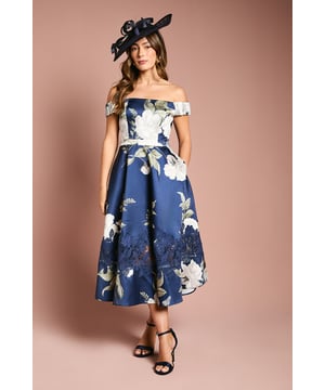 Elegant Bardot neckline with delicate off-shoulder design
        Striking floral print with intricate lace insert detailing
        Flattering midi length with full, structured skirt
        Twill fabric offering excellent structure and shape retention
        Fully lined for comfort and a smooth silhouette
    
    Make a statement at your next special occasion with this exquisite Bardot twill midi dress from Coast. The sophisticated off-shoulder neckline frames your dcolletage beautifully, while the structured skirt creates a truly feminine silhouette. The eye-catching floral print is enhanced with delicate lace inserts, adding texture and dimension to this stunning piece. Perfect for weddings, the races or summer garden parties, this dress pairs wonderfully with strappy heels and a statement fascinator as shown. For cooler evenings, add a lightweight wrap or tailored jacket. The midi length offers versatility and elegance, ensuring you look refined yet contemporary at any formal gathering. This Coast creation embodies timeless sophistication with a modern twist.