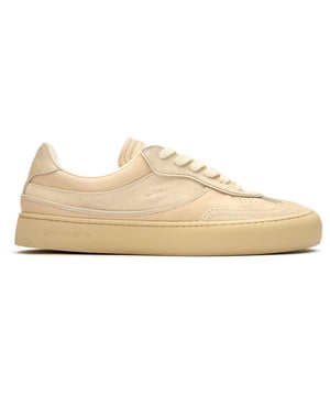The Good News Lagoon trainers blend retro court styling with eco-conscious craftsmanship. These sand-colored kicks showcase handmade deadstock suede uppers with a distinctive stamped GN motif that adds subtle branding. The chunky organic cotton laces provide a textural contrast against the soft suede, while recycled mesh lining ensures breathable comfort. Perfect for the environmentally mindful gentleman seeking casual footwear with substance, these rubber-soled trainers deliver on both sustainability and laid-back style.