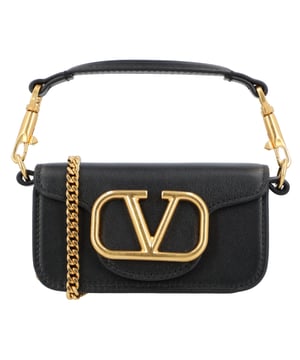 Small Valentino Garavani Locò shoulder bag in calfskin with metallic VLogo signature detail. Thanks to the two straps – a removable and sliding chain strap and a removable top handle – this accessory can be worn as a handbag, shoulder bag, or crossbody bag.
– Metal hardware with a metallic antique brass finish
– Magnetic closure
– Removable leather handle
– Shoulder strap with removable and sliding chain strap
– Nappa leather lining. Interior: Open pocket
– Shoulder strap length: 55 cm
– Made in Italy
– Dimensions: Width: 13 cm Height: 7 cm Depth: 4.5 cm Measurments:  width: 130 mm height: 70 mm strap length: 550 mm
