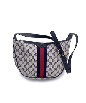 VINTAGE, RRP AS NEW
A true classic from GUCCI's elegant archives, this vintage monogram shoulder bag captures the quiet sophistication of an earlier era. Crafted in the brand's iconic blue GG monogram canvas, it's thoughtfully trimmed with smooth genuine leather, and completed with a sturdy adjustable leather shoulder strap-a timeless silhouette that feels both refined and effortlessly wearable.  The upper zipper closure reveals a blue leather interior with a single side zip pocket-simple, elegant, and practical. Inside, a heat-stamped "GUCCI Accessory Collection - Made in Italy" tag stands as a testament to the brand's fine Italian heritage and enduring craftsmanship.  Whether you carry it daily or reserve it for special vintage moments, this piece is more than an accessory-it's a beautiful echo of GUCCI's iconic style, designed to age gracefully and carry stories of its own. Condition Rating: B - VERY GOOD CONDITIONCondition Details: Gently used. Some normal wear of use on leather trim. Some normal wear of use on the internal lining. Please check the photos carefully and ask if you need to know more details or if you have any doubts.Measurements (cm):Depth: 7.6Height: 22.9Length: 30.5Other Details: Dustbag? NoKeys? NoBox? No Measurments:  width: 76 mm length: 305 mm height: 229 mm