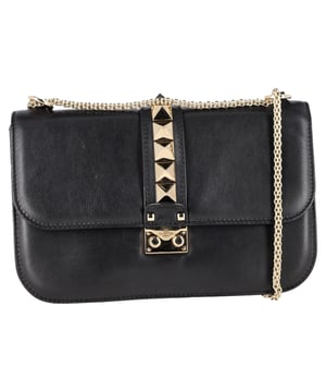 VINTAGE, RRP AS NEW
The Valentino Medium Rockstud Glam Lock Shoulder Bag in black leather combines edgy elegance with iconic style, featuring signature pyramid studs and a bold chain strap. Its compact yet structured design makes it the perfect statement piece for both casual outings and evening events. **Styling Tip:** Wear it with a leather jacket and pointed heels to amplify its rock-chic allure.

Valentino Medium Rockstud Glam Lock Shoulder Bag in Black Leather

Condition: Excellent
Signs of wear: No retail tag, No visible sign of wear., 
Packaging: None
Color: Black
Material: Leather | calfskin leather
Size: One Size | One Size
Measurements: Width: 80; Height: 170; Length: 270
SKU: NAPPUGBBA489578W
