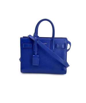 VINTAGE, RRP AS NEW
This beautiful Bag will come with a Certificate of ity provided by Entrupy. The certificate will be provided at no further cost  This stunning Saint Laurent 'Sac de Jour' tote bag in a rich blue leather hue is the epitome of luxury and craftsmanship. The Nano version offers a compact yet elegant design, making it perfect for those who love both style and functionality. It features double top carry handles and a removable, adjustable shoulder strap for versatile carrying options. Inside, you'll find a spacious main compartment with a small pocket for added organization.  The suede lining adds a soft, refined touch, while the gold metal hardware exudes sophistication. A removable padlock adds an extra layer of charm (keys are included). With 5 bottom feet to protect the leather, this bag is as durable as it is stylish. Inside, you'll spot the iconic 'SAINT LAURENT Paris' tag and a serial number tag tucked inside the interior pocket. Retailing at €2100, this bag is a true investment piece for any fashion aficionado. Condition Rating: B - VERY GOOD CONDITIONCondition Details: Gently used. Some normal wear of use on leather. (light scratches) Some normal wear of use on bottom corners. Some normal wear of use internally. Please check the photos carefully and ask if you need to know more details or if you have any doubts.Measurements (cm):Depth: 10.2Height: 16.5Length: 21.6Other Details: Dustbag? NoKeys? NoBox? No Measurments:  width: 102 mm length: 216 mm height: 165 mm strap length: 0 mm handle drop: 0 mm