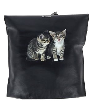 VINTAGE, RRP AS NEW
Playfully subversive and unmistakably Balenciaga, the Kitten Shopping Bag is Demna Gvasalia’s latest cult creation. Crafted in Italy from supple black calfskin leather, this structured shopper features a minimalist silhouette juxtaposed with a cheeky kitten print—adding a touch of whimsy to its elevated design. With an open-top layout for easy access to your essentials, it’s the perfect everyday statement piece for those who favor irony with elegance.


Balenciaga Kitten Shopping Bag in Black Calfskin Leather
Condition: Very good
Signs of wear: Lightly used but very well maintained. Minor creasing, light worn corners, light scratches., Minor sign of wear or markings., No retail tag
Packaging: Dust bag
Color: 
Material: Leather | sheep leather
Size: One Size | One Size
Measurements: Width: 90; Height: 440; Length: 340; Handle drop: 120; Strap length: 330
SKU: NAPPUGBBA513767W
