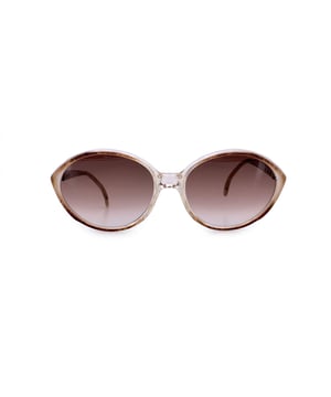 VINTAGE, RRP AS NEW
Embrace the refined elegance of 1980s eyewear with these vintage Yves Saint Laurent sunglasses, model ATREE (58/16)-a rare and beautifully preserved piece that captures the era's sophisticated glamour. Made in France, this model features a unique transparent frame with warm brown accents, paired with gold metal detailing on the arms for a touch of understated luxury.  The gradient brown lenses offer 100% UV protection, blending practicality with timeless style. Subtle yet iconic, the YSL logos on the temples mark this piece as a true designer classic. The ATREE model is a statement of quiet confidence-elegant, rare, and a perfect addition to any vintage eyewear collection. Condition Rating: A - EXCELLENTCondition Details: Gently Used. Lenses and frame in excellent condition. Please check the images carefully. Some show arrows indicating any evident defect. Please ask if you need to know more details or if you have any doubts. Glasses maximum Width: 130mm Glasses Temple 140mm Glasses maximum lens width: 56mm Glasses maximum lens 46mm Glasses bridge width: 16mm Measurments:  width: 130 mm length: 56 mm height: 46 mm
