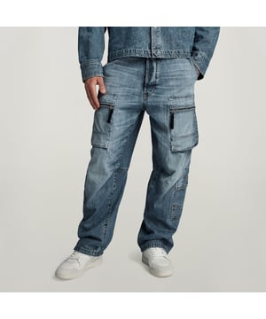 Inset pockets and coin pocket - rivet reinforced. 3D zip pockets at the thigh. Flap pockets at the lower leg and back. Adjustable leg width- pull cord inside. Button closure. Mid waist. Cargo pants Multi pocket is designed in a relaxed fit. A tighter fit around the ankles can be created by pulling the drawcords inside. 100% Cotton. Premium denim, 10.8 oz weight. 2x1 right hand twill. Loose