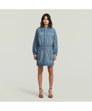 Band collar. Snap button closure. Flap pockets, hidden snap buttons. Adjustable tabs at the waist, snap buttons. Sleeve slit, snap button closure. Snap button. Dress Macro Balloon is designed in a short length and offers voluminous sleeves. The lowered shoulder panel adds to the loose fit. Use the tabs to add more shape to the waist. This denim dress combines a band collar with a snap button closure. Also the 3D-flap pockets close with snaps, but these are placed concealed. 100% Cotton. Rigid. Loose
