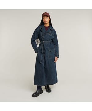 Flat collar. Zipper closure. Side seam pockets, flap pocket with snap button, zip pocket at the chest. Adjustable belt at the waist and cuffs. Back slit. Zip closure. Denim trench Biker is designed in a loose fit and offers a maxi length. Either keep the zipper partly open for a wide spread collar or close it fully for a different look with a flat collar. The belt at the waist and cuffs allows for a tighter fit with more volume. Pockets at the side seam are combined with a flap pocket at the front. A zip pocket is added to the chest. 95% Cotton, 5% Recycled cotton. Rigid. Loose