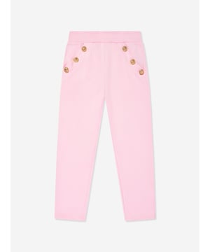 Balmain embody distinctive Parisian sensibilities in their immaculate designs. These girls pink gold joggers are reflective of the label's passion for raw innovation. Made in the finest cotton jersey with embellished gold buttons, a ribbed elasticated waistband, and front short side pockets. Straight Hem 100 Cotton Trim 95 Cotton, 5 Elastane